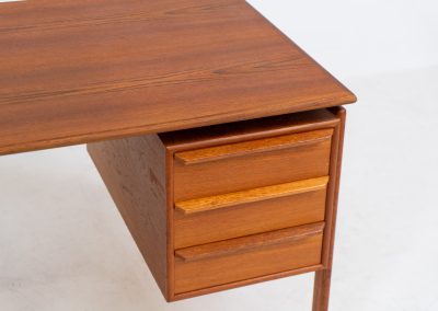 Teak writing desk by Arne Vodder for G.V. Møbler (Denmark, 1960s). This exceptionally beautiful piece is a true example of top-quality Danish craftsmanship. Made from teak, it showcases elegant aesthetics with softly rounded edges and a floating desk top. It contains six very deep drawers and a finished backside, making it an ideal piece for placement in the center of a room. The desk is in excellent condition.