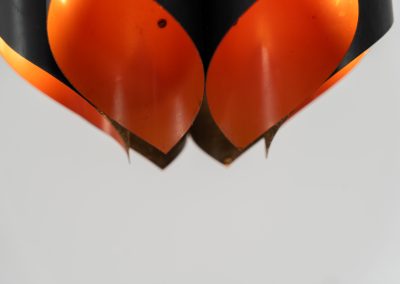 Sculptural pendant light by Bent Karlby for Lyfa (Denmark, 1960s). A bold, architectural design with folded metal shades in black and orange, creating a striking contrast and a warm, indirect glow. The layered construction plays with light and shadow, giving the piece a dynamic, almost graphic presence. A true mid-century statement. Compact, sculptural, and highly distinctive. Perfect as a focal point in any interior. In very good condition with age related wear.