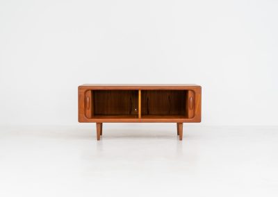 Beautiful lowboard with tambour doors by Svend Dyrlund (Denmark, 1960s). This elegant Danish piece, crafted in teak, features nice organic edges, refined tambour doors, and beautiful solid handles. The back has a factory hole that can be screwed open for cable management, making it a perfect piece for a television or audio gear! This piece is in splendid condition!