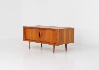 Beautiful lowboard with tambour doors by Svend Dyrlund (Denmark, 1960s). This elegant Danish piece, crafted in teak, features nice organic edges, refined tambour doors, and beautiful solid handles. The back has a factory hole that can be screwed open for cable management, making it a perfect piece for a television or audio gear! This piece is in splendid condition!