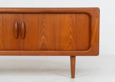 Beautiful lowboard with tambour doors by Svend Dyrlund (Denmark, 1960s). This elegant Danish piece, crafted in teak, features nice organic edges, refined tambour doors, and beautiful solid handles. The back has a factory hole that can be screwed open for cable management, making it a perfect piece for a television or audio gear! This piece is in splendid condition!