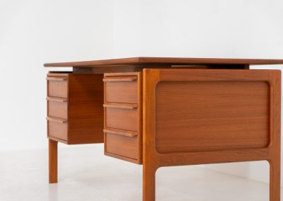 Teak writing desk by Arne Vodder for G.V. Møbler (Denmark, 1960s). This exceptionally beautiful piece is a true example of top-quality Danish craftsmanship. Made from teak, it showcases elegant aesthetics with softly rounded edges and a floating desk top. It contains six very deep drawers and a finished backside, making it an ideal piece for placement in the center of a room. The desk is in excellent condition.
