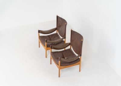 Pair of “Modus” armchairs by Kristian Vedel for Søren Willadsen (Denmark, 1960s). A rare and authentic set of two lounge chairs crafted from solid oak with beautifully detailed joinery. The frames have been carefully refreshed while preserving the wood's original character and warm patina. The brown leather has been cleaned and conditioned, showing attractive age and wear consistent with its vintage nature. A great example of Danish mid-century design, combining elegant sculptural lines with exceptional comfort thanks to the wide seats, suspended leather backs, and generous cushions.