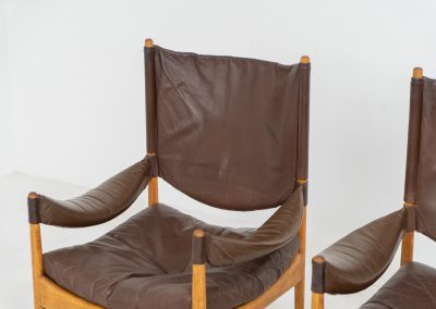 Pair of “Modus” armchairs by Kristian Vedel for Søren Willadsen (Denmark, 1960s). A rare and authentic set of two lounge chairs crafted from solid oak with beautifully detailed joinery. The frames have been carefully refreshed while preserving the wood's original character and warm patina. The brown leather has been cleaned and conditioned, showing attractive age and wear consistent with its vintage nature. A great example of Danish mid-century design, combining elegant sculptural lines with exceptional comfort thanks to the wide seats, suspended leather backs, and generous cushions.