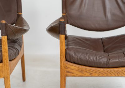 Pair of “Modus” armchairs by Kristian Vedel for Søren Willadsen (Denmark, 1960s). A rare and authentic set of two lounge chairs crafted from solid oak with beautifully detailed joinery. The frames have been carefully refreshed while preserving the wood's original character and warm patina. The brown leather has been cleaned and conditioned, showing attractive age and wear consistent with its vintage nature. A great example of Danish mid-century design, combining elegant sculptural lines with exceptional comfort thanks to the wide seats, suspended leather backs, and generous cushions.