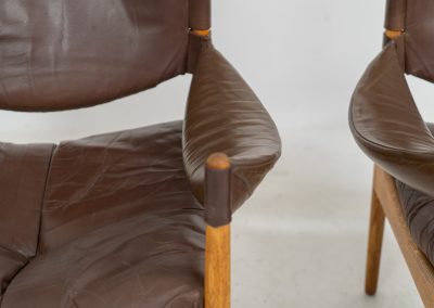 Pair of “Modus” armchairs by Kristian Vedel for Søren Willadsen (Denmark, 1960s). A rare and authentic set of two lounge chairs crafted from solid oak with beautifully detailed joinery. The frames have been carefully refreshed while preserving the wood's original character and warm patina. The brown leather has been cleaned and conditioned, showing attractive age and wear consistent with its vintage nature. A great example of Danish mid-century design, combining elegant sculptural lines with exceptional comfort thanks to the wide seats, suspended leather backs, and generous cushions.