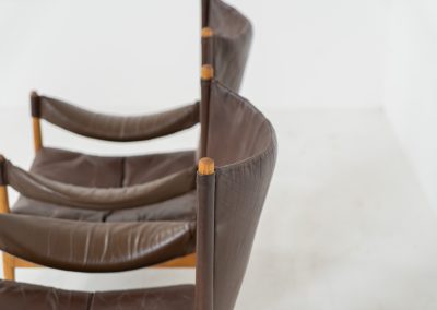 Pair of “Modus” armchairs by Kristian Vedel for Søren Willadsen (Denmark, 1960s). A rare and authentic set of two lounge chairs crafted from solid oak with beautifully detailed joinery. The frames have been carefully refreshed while preserving the wood's original character and warm patina. The brown leather has been cleaned and conditioned, showing attractive age and wear consistent with its vintage nature. A great example of Danish mid-century design, combining elegant sculptural lines with exceptional comfort thanks to the wide seats, suspended leather backs, and generous cushions.