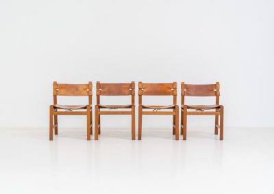 Oak & leather dining chairs (Denmark, 1960s). This exceptional set of dining chairs features solid oak frames paired with saddle leather seats. The design is reminiscent of Børge Mogensen’s “Spanish” dining chairs and could possibly be an lesser-known design by Mogensen, although this cannot be confirmed. The leather is in well-used condition with a beautiful, authentic patina. It shows some surface cracking, but this is limited to the top layer only and does not affect the structural integrity or strength of the seats.