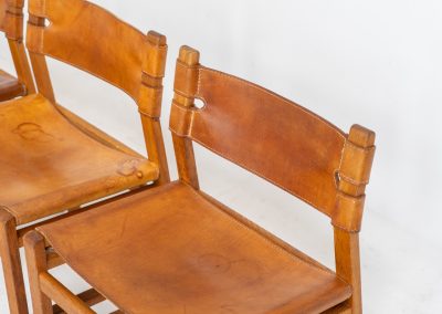 Oak & leather dining chairs (Denmark, 1960s). This exceptional set of dining chairs features solid oak frames paired with saddle leather seats. The design is reminiscent of Børge Mogensen’s “Spanish” dining chairs and could possibly be an lesser-known design by Mogensen, although this cannot be confirmed. The leather is in well-used condition with a beautiful, authentic patina. It shows some surface cracking, but this is limited to the top layer only and does not affect the structural integrity or strength of the seats.