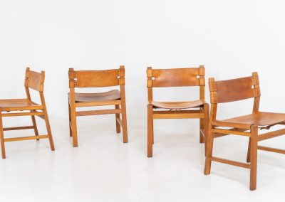 Oak & leather dining chairs (Denmark, 1960s). This exceptional set of dining chairs features solid oak frames paired with saddle leather seats. The design is reminiscent of Børge Mogensen’s “Spanish” dining chairs and could possibly be an lesser-known design by Mogensen, although this cannot be confirmed. The leather is in well-used condition with a beautiful, authentic patina. It shows some surface cracking, but this is limited to the top layer only and does not affect the structural integrity or strength of the seats.