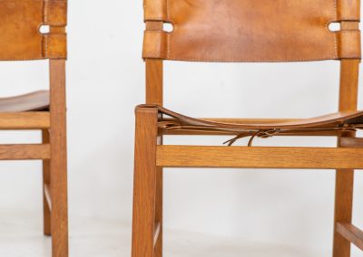 Oak & leather dining chairs (Denmark, 1960s). This exceptional set of dining chairs features solid oak frames paired with saddle leather seats. The design is reminiscent of Børge Mogensen’s “Spanish” dining chairs and could possibly be an lesser-known design by Mogensen, although this cannot be confirmed. The leather is in well-used condition with a beautiful, authentic patina. It shows some surface cracking, but this is limited to the top layer only and does not affect the structural integrity or strength of the seats.