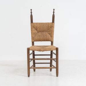 Vintage Spanish side chair, 1950s. This chair features a beautifully sculptural silhouette, crafted from a solid stained beech frame with a handwoven rush seat. Its minimalist yet expressive form adds warmth and texture to any interior. In good condition, with a rich natural patina and visible signs of use that enhance its character.
