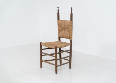 Vintage Spanish side chair, 1950s. This chair features a beautifully sculptural silhouette, crafted from a solid stained beech frame with a handwoven rush seat. Its minimalist yet expressive form adds warmth and texture to any interior. In good condition, with a rich natural patina and visible signs of use that enhance its character.