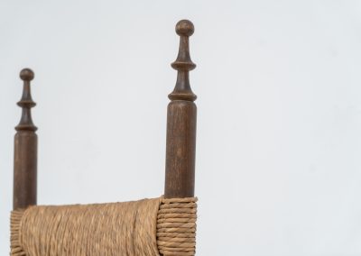 Vintage Spanish side chair, 1950s. This chair features a beautifully sculptural silhouette, crafted from a solid stained beech frame with a handwoven rush seat. Its minimalist yet expressive form adds warmth and texture to any interior. In good condition, with a rich natural patina and visible signs of use that enhance its character.