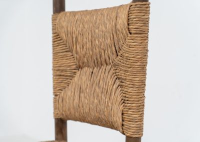 Vintage Spanish side chair, 1950s. This chair features a beautifully sculptural silhouette, crafted from a solid stained beech frame with a handwoven rush seat. Its minimalist yet expressive form adds warmth and texture to any interior. In good condition, with a rich natural patina and visible signs of use that enhance its character.