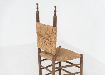 Vintage Spanish side chair, 1950s. This chair features a beautifully sculptural silhouette, crafted from a solid stained beech frame with a handwoven rush seat. Its minimalist yet expressive form adds warmth and texture to any interior. In good condition, with a rich natural patina and visible signs of use that enhance its character.