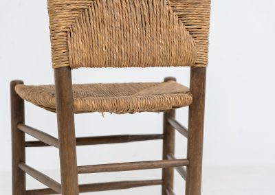 Vintage Spanish side chair, 1950s. This chair features a beautifully sculptural silhouette, crafted from a solid stained beech frame with a handwoven rush seat. Its minimalist yet expressive form adds warmth and texture to any interior. In good condition, with a rich natural patina and visible signs of use that enhance its character.