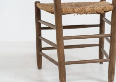 Vintage Spanish side chair, 1950s. This chair features a beautifully sculptural silhouette, crafted from a solid stained beech frame with a handwoven rush seat. Its minimalist yet expressive form adds warmth and texture to any interior. In good condition, with a rich natural patina and visible signs of use that enhance its character.