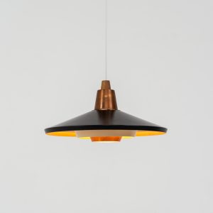 Striking Danish pendant light (Denmark, 1950s). This striking vintage pendant lamp features a refined combination of copper, lacquered metal and teak wood. Its perfectly balanced and sculptural silhouette creates a warm, atmospheric glow while adding a bold design statement to any interior. The lamp is in very good condition with a stunning patina to the copper.