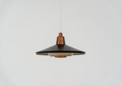Striking Danish pendant light (Denmark, 1950s). This striking vintage pendant lamp features a refined combination of copper, lacquered metal and teak wood. Its perfectly balanced and sculptural silhouette creates a warm, atmospheric glow while adding a bold design statement to any interior. The lamp is in very good condition with a stunning patina to the copper.