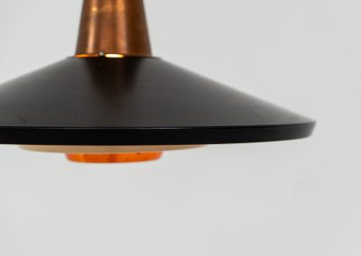 Striking Danish pendant light (Denmark, 1950s). This striking vintage pendant lamp features a refined combination of copper, lacquered metal and teak wood. Its perfectly balanced and sculptural silhouette creates a warm, atmospheric glow while adding a bold design statement to any interior. The lamp is in very good condition with a stunning patina to the copper.
