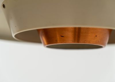 Striking Danish pendant light (Denmark, 1950s). This striking vintage pendant lamp features a refined combination of copper, lacquered metal and teak wood. Its perfectly balanced and sculptural silhouette creates a warm, atmospheric glow while adding a bold design statement to any interior. The lamp is in very good condition with a stunning patina to the copper.