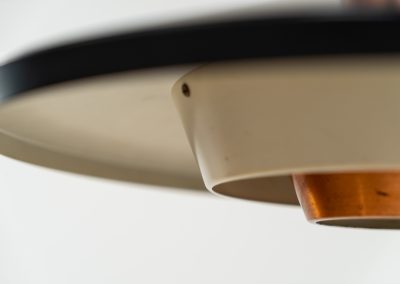 Striking Danish pendant light (Denmark, 1950s). This striking vintage pendant lamp features a refined combination of copper, lacquered metal and teak wood. Its perfectly balanced and sculptural silhouette creates a warm, atmospheric glow while adding a bold design statement to any interior. The lamp is in very good condition with a stunning patina to the copper.
