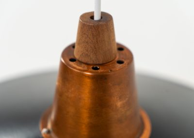 Striking Danish pendant light (Denmark, 1950s). This striking vintage pendant lamp features a refined combination of copper, lacquered metal and teak wood. Its perfectly balanced and sculptural silhouette creates a warm, atmospheric glow while adding a bold design statement to any interior. The lamp is in very good condition with a stunning patina to the copper.