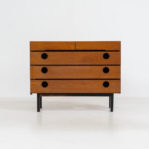 Teak shoe cabinet (Germany, 1960s). The cabinet features two small drawers and three shelves for shoe storage. It is made of teak and has a black lacquered frame with black inset handles that allow for proper ventilation. The cabinet is in good condition, with some visible signs of use.