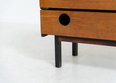 Teak shoe cabinet (Germany, 1960s). The cabinet features two small drawers and three shelves for shoe storage. It is made of teak and has a black lacquered frame with black inset handles that allow for proper ventilation. The cabinet is in good condition, with some visible signs of use.