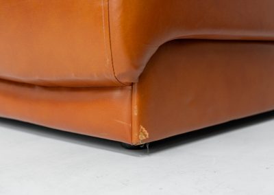 Modular sofa by Doimo Salotti (Italy, 1970s). Striking and bold modular seating system consisting of five identical elements and one corner piece, upholstered in their original cognac leather. Can be arranged as a sofa or used as individual lounge chairs. Low, sculptural design with generous padding, offering both strong visual impact and excellent comfort. The sofa is in very good condition with some age-related signs of use, as shown in the pictures. Most traces of use are discreet and not immediately visible. Marked by the maker.