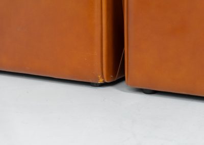 Modular sofa by Doimo Salotti (Italy, 1970s). Striking and bold modular seating system consisting of five identical elements and one corner piece, upholstered in their original cognac leather. Can be arranged as a sofa or used as individual lounge chairs. Low, sculptural design with generous padding, offering both strong visual impact and excellent comfort. The sofa is in very good condition with some age-related signs of use, as shown in the pictures. Most traces of use are discreet and not immediately visible. Marked by the maker.
