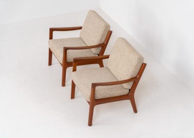 Pair of “Senator” easy chairs by Ole Wanscher for France & Son (Denmark, 1960s). An elegant pair of easy chairs and a fine example of Scandinavian Modernism. They feature a solid teak frame with a warm, natural grain, beautifully sculpted curves, and comfortable cushions upholstered in their original beige wool fabric. The chairs present beautifully and are in mint condition, fully labeled by the maker.