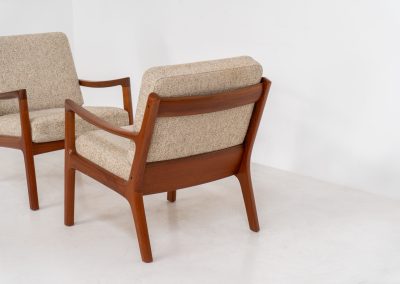 Pair of “Senator” easy chairs by Ole Wanscher for France & Son (Denmark, 1960s). An elegant pair of easy chairs and a fine example of Scandinavian Modernism. They feature a solid teak frame with a warm, natural grain, beautifully sculpted curves, and comfortable cushions upholstered in their original beige wool fabric. The chairs present beautifully and are in mint condition, fully labeled by the maker.