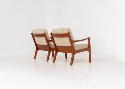 Pair of “Senator” easy chairs by Ole Wanscher for France & Son (Denmark, 1960s). An elegant pair of easy chairs and a fine example of Scandinavian Modernism. They feature a solid teak frame with a warm, natural grain, beautifully sculpted curves, and comfortable cushions upholstered in their original beige wool fabric. The chairs present beautifully and are in mint condition, fully labeled by the maker.