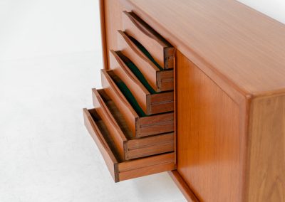Sideboard in teak Svend Dyrlund (Denmark, 1960s). A beautifully crafted piece showcasing exceptional Danish design and craftsmanship. It features two sliding doors with adjustable shelves and six elegant drawers, offering generous and flexible storage. The softly rounded edges and organic lines give the sideboard a refined, timeless character. In very good condition.