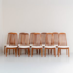 Set of 10 dining chairs by Kai Kristiansen for Schou Andersen (Denmark, 1950s). A stunning set of mid-century dining chairs, crafted with solid teak frames and featuring organically sculpted backrests. The seats are newly upholstered in a beautifully textured off-white fabric. The set of chairs presents itself in splendid condition.