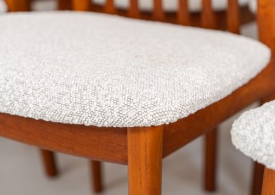 Set of 10 dining chairs by Kai Kristiansen for Schou Andersen (Denmark, 1950s). A stunning set of mid-century dining chairs, crafted with solid teak frames and featuring organically sculpted backrests. The seats are newly upholstered in a beautifully textured off-white fabric. The set of chairs presents itself in splendid condition.
