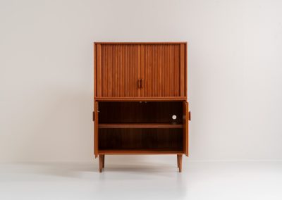 Highboard with tambour doors by Heinrich Riestenpatt for RT Möbel (Germany, 1960s). This rarely seen highboard is made by German designer Heinrich Riestenpatt, executed in warm teak. The clean, architectural form is complemented by stunning tambour doors, organic handles and beautifully balanced proportions. A distinctive feature of this piece is the extractable shelve in the cabinet, making it ideal to use for a vinyl player. A timeless example of German modern design, presented in excellent vintage condition.