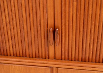 Highboard with tambour doors by Heinrich Riestenpatt for RT Möbel (Germany, 1960s). This rarely seen highboard is made by German designer Heinrich Riestenpatt, executed in warm teak. The clean, architectural form is complemented by stunning tambour doors, organic handles and beautifully balanced proportions. A distinctive feature of this piece is the extractable shelve in the cabinet, making it ideal to use for a vinyl player. A timeless example of German modern design, presented in excellent vintage condition.