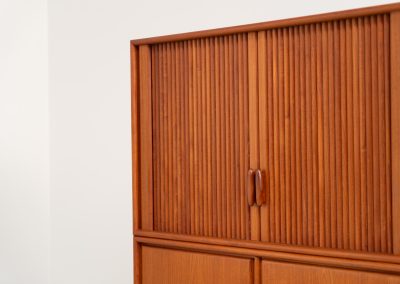 Highboard with tambour doors by Heinrich Riestenpatt for RT Möbel (Germany, 1960s). This rarely seen highboard is made by German designer Heinrich Riestenpatt, executed in warm teak. The clean, architectural form is complemented by stunning tambour doors, organic handles and beautifully balanced proportions. A distinctive feature of this piece is the extractable shelve in the cabinet, making it ideal to use for a vinyl player. A timeless example of German modern design, presented in excellent vintage condition.