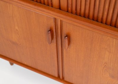 Highboard with tambour doors by Heinrich Riestenpatt for RT Möbel (Germany, 1960s). This rarely seen highboard is made by German designer Heinrich Riestenpatt, executed in warm teak. The clean, architectural form is complemented by stunning tambour doors, organic handles and beautifully balanced proportions. A distinctive feature of this piece is the extractable shelve in the cabinet, making it ideal to use for a vinyl player. A timeless example of German modern design, presented in excellent vintage condition.
