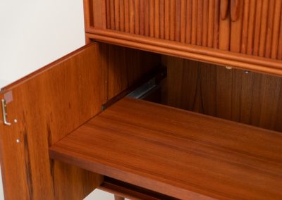 Highboard with tambour doors by Heinrich Riestenpatt for RT Möbel (Germany, 1960s). This rarely seen highboard is made by German designer Heinrich Riestenpatt, executed in warm teak. The clean, architectural form is complemented by stunning tambour doors, organic handles and beautifully balanced proportions. A distinctive feature of this piece is the extractable shelve in the cabinet, making it ideal to use for a vinyl player. A timeless example of German modern design, presented in excellent vintage condition.