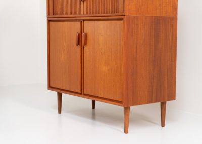 Highboard with tambour doors by Heinrich Riestenpatt for RT Möbel (Germany, 1960s). This rarely seen highboard is made by German designer Heinrich Riestenpatt, executed in warm teak. The clean, architectural form is complemented by stunning tambour doors, organic handles and beautifully balanced proportions. A distinctive feature of this piece is the extractable shelve in the cabinet, making it ideal to use for a vinyl player. A timeless example of German modern design, presented in excellent vintage condition.