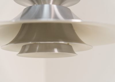 Brushed aluminium pendant light by Frandsen (Denmark, 1970s). A beautiful lamp made out of four aluminium shades and featuring an elegant silhouette. The lamp remains in splendid condition.