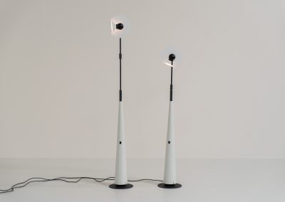 Stunning pair of “Club 1095” floor lamps by Giuseppe Ramella for Arteluce (Italy, 1980s). A beautiful example of Italian minimalist design, the Club 1095 combines a clean, architectural silhouette with a highly functional design. The height of the lamp is adjustable, while the diffuser can be angled to direct the light exactly where it is needed. With their understated presence and timeless aesthetic, these lamps work beautifully in both contemporary and more eclectic interiors, equally striking as a pair or as a standalone piece. Both lamps are in excellent vintage condition. Available individually or as a pair.