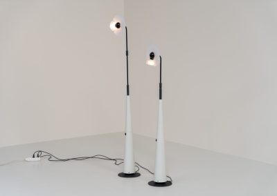 Stunning pair of “Club 1095” floor lamps by Giuseppe Ramella for Arteluce (Italy, 1980s). A beautiful example of Italian minimalist design, the Club 1095 combines a clean, architectural silhouette with a highly functional design. The height of the lamp is adjustable, while the diffuser can be angled to direct the light exactly where it is needed. With their understated presence and timeless aesthetic, these lamps work beautifully in both contemporary and more eclectic interiors, equally striking as a pair or as a standalone piece. Both lamps are in excellent vintage condition. Available individually or as a pair.
