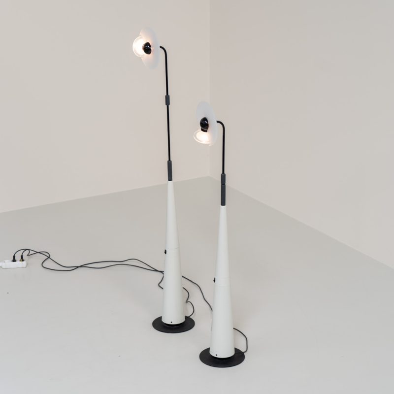 Stunning pair of “Club 1095” floor lamps by Giuseppe Ramella for Arteluce (Italy, 1980s). A beautiful example of Italian minimalist design, the Club 1095 combines a clean, architectural silhouette with a highly functional design. The height of the lamp is adjustable, while the diffuser can be angled to direct the light exactly where it is needed. With their understated presence and timeless aesthetic, these lamps work beautifully in both contemporary and more eclectic interiors, equally striking as a pair or as a standalone piece. Both lamps are in excellent vintage condition. Available individually or as a pair.