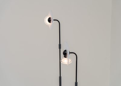 Stunning pair of “Club 1095” floor lamps by Giuseppe Ramella for Arteluce (Italy, 1980s). A beautiful example of Italian minimalist design, the Club 1095 combines a clean, architectural silhouette with a highly functional design. The height of the lamp is adjustable, while the diffuser can be angled to direct the light exactly where it is needed. With their understated presence and timeless aesthetic, these lamps work beautifully in both contemporary and more eclectic interiors, equally striking as a pair or as a standalone piece. Both lamps are in excellent vintage condition. Available individually or as a pair.