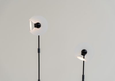 Stunning pair of “Club 1095” floor lamps by Giuseppe Ramella for Arteluce (Italy, 1980s). A beautiful example of Italian minimalist design, the Club 1095 combines a clean, architectural silhouette with a highly functional design. The height of the lamp is adjustable, while the diffuser can be angled to direct the light exactly where it is needed. With their understated presence and timeless aesthetic, these lamps work beautifully in both contemporary and more eclectic interiors, equally striking as a pair or as a standalone piece. Both lamps are in excellent vintage condition. Available individually or as a pair.